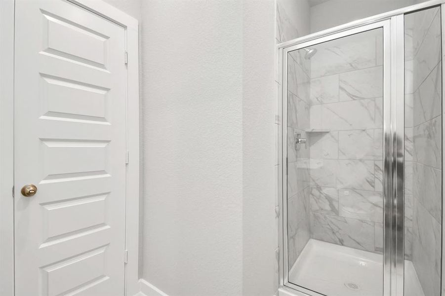 Take a look at the walk-in shower at the guest bathroom. Sample photo of completed home with similar floor plan. Actual colors and selections may vary.