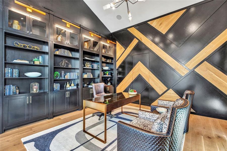 Home office featuring light wood-style floors, lofted ceiling and built in features Home office featuring light wood-style floors, lofted ceiling and built in features