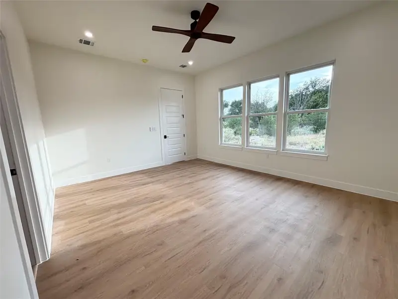 Natural light streams into this generously sized room, highlighting the clean, modern flooring. Natural light streams into this generously sized room, highlighting the clean, modern flooring.