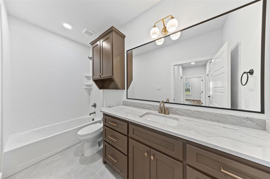 Full bathroom featuring vanity, shower / bath combination, recessed lighting, and light tile patterned floors Full bathroom featuring vanity, shower / bath combination, recessed lighting, and light tile patterned floors