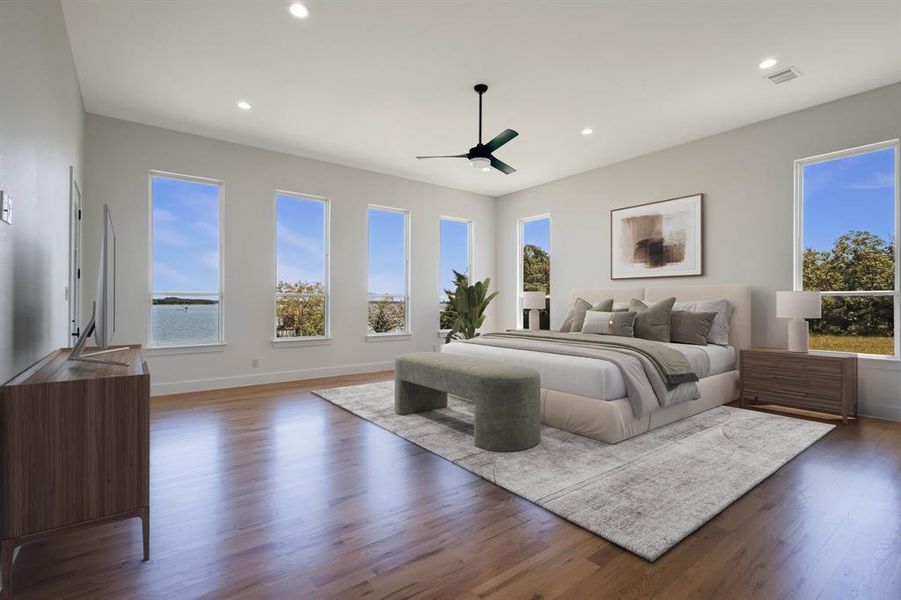 Spacious room featuring multiple rectangular windows, wood-finish flooring, recessed lighting, and a ceiling fan
