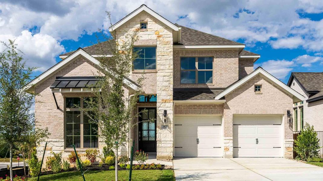 View of front of home with stone siding, brick siding, driveway, and a shingled roof View of front of home with stone siding, brick siding, driveway, and a shingled roof