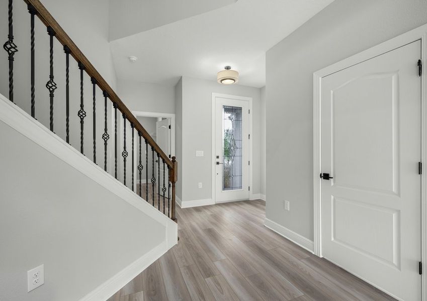 Foyer with a full lite front door and staircase