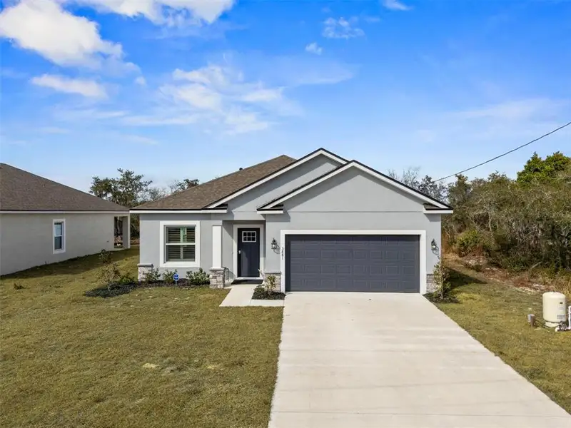Front exterior of a new home in , Lake Wales, FL, highlighting curb appeal (Image 1). Front exterior of a new home in , Lake Wales, FL, highlighting curb appeal (Image 1).