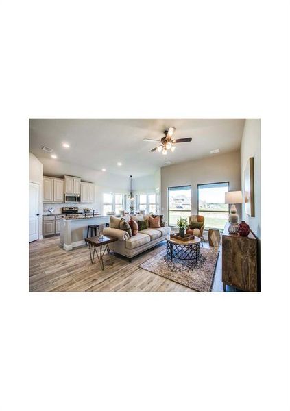 Living room with light wood-type flooring and ceiling fan