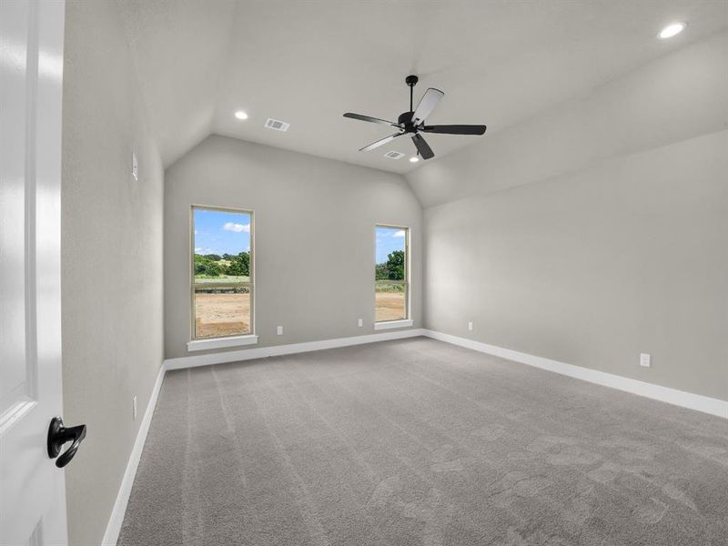 Carpeted spare room with vaulted ceiling, recessed lighting, and a ceiling fan Carpeted spare room with vaulted ceiling, recessed lighting, and a ceiling fan