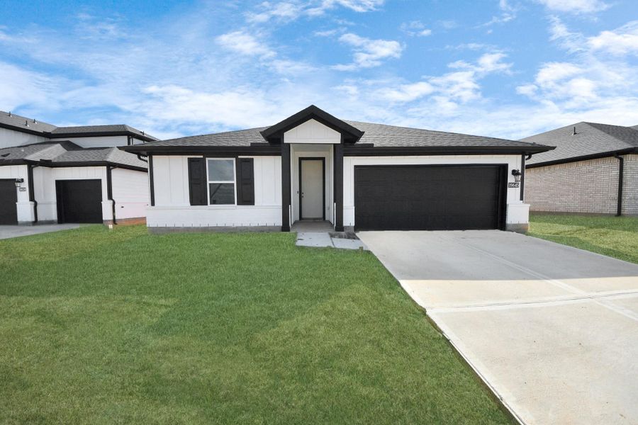 Actual exterior of home, construction - 90% complete. Glass front door, landscaping, and perimeter fence pending installation. Welcome home to 19645 Montgomery Ridge Way located in Montgomery Ridge community and zoned to highly sought after Montgomery ISD.