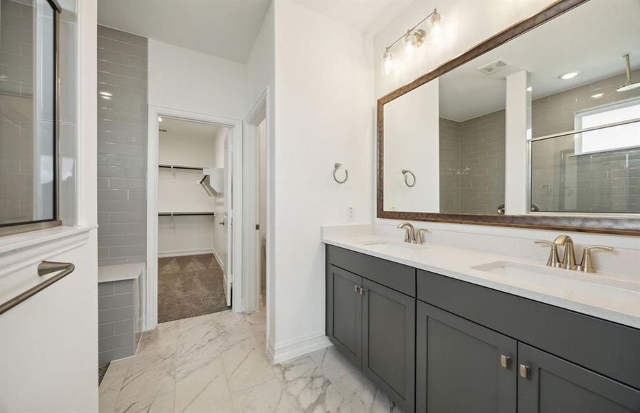 Elegant owner's bath with dual vanity *real home pictured