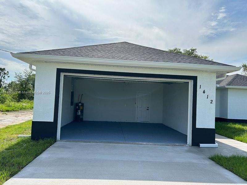 Front exterior of a new home in , Lehigh Acres, FL, highlighting curb appeal (Image 9). Front exterior of a new home in , Lehigh Acres, FL, highlighting curb appeal (Image 9).
