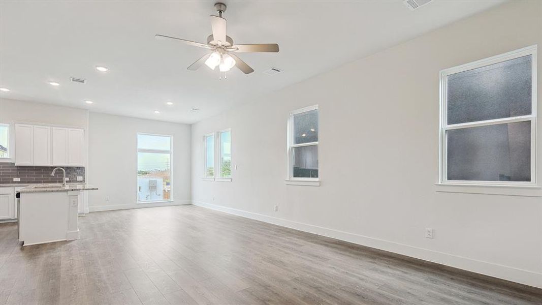 Open-concept living area with wood-finish flooring