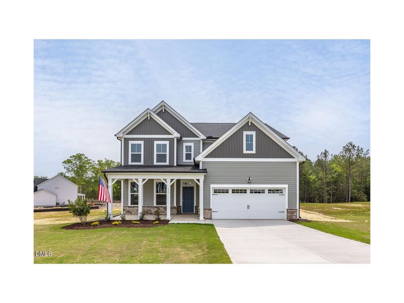 Front exterior of a new home in Woodland Crossing, Zebulon, NC, highlighting curb appeal (Image 1).