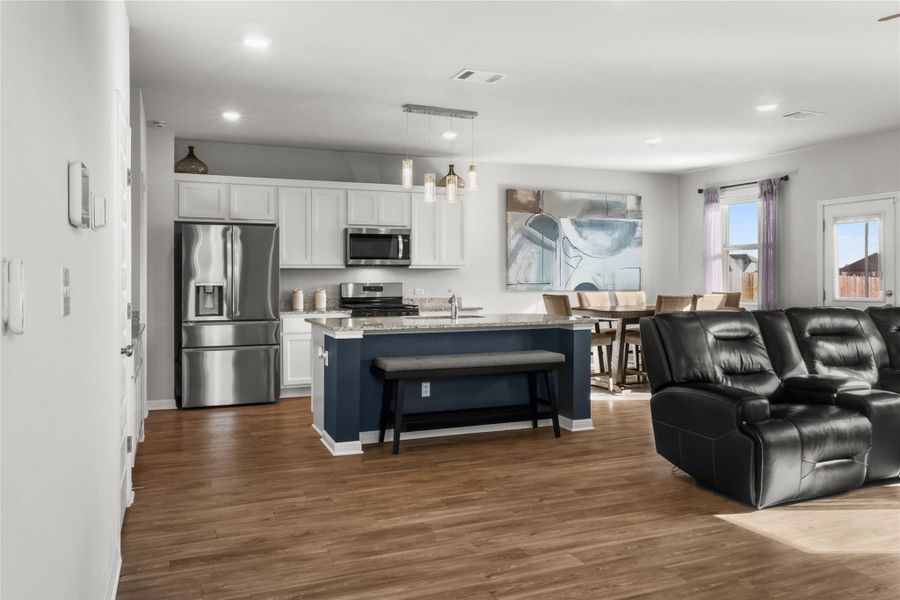 Living room featuring dark wood-type flooring and recessed lighting
