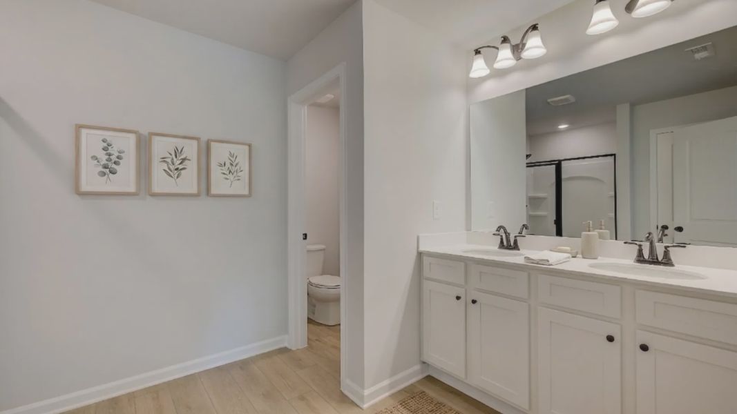 Bathroom with dual vanity and separate area for water closet Bathroom with dual vanity and separate area for water closet