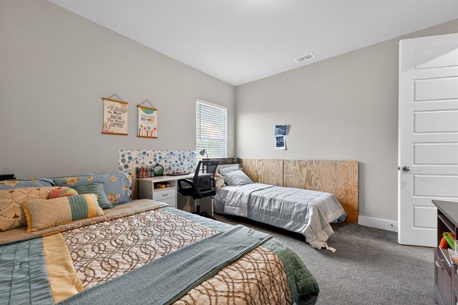 The property features a room with light grey walls, carpeted flooring, and a white paneled door