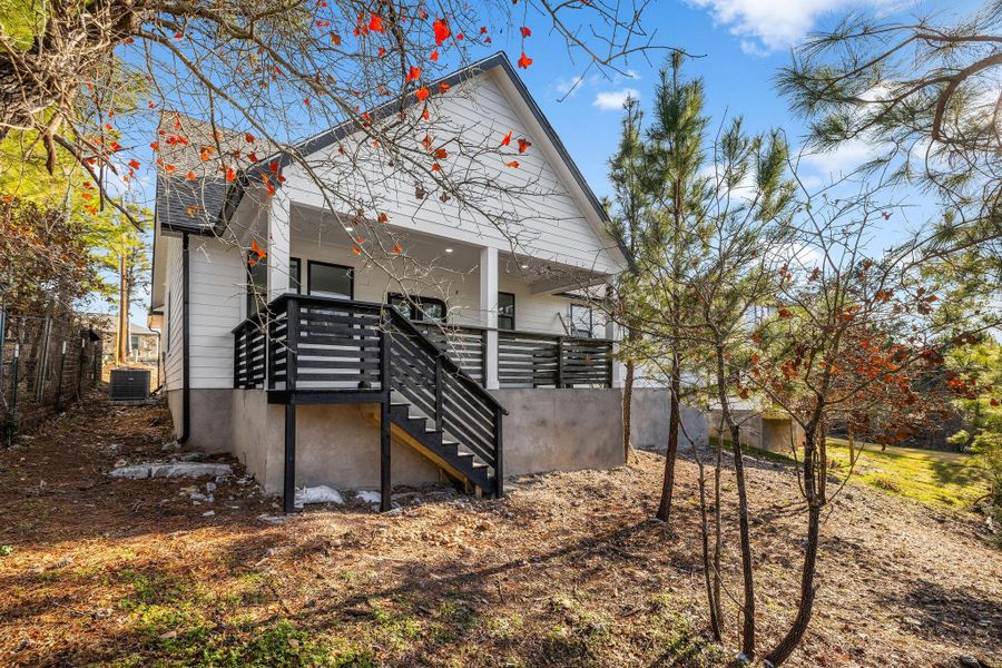 Rear view of house with stairs to covered patio.