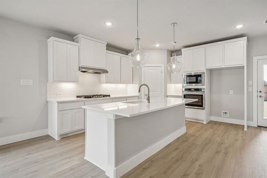 Kitchen featuring appliances with stainless steel finishes, white cabinetry, and recessed lighting Kitchen featuring appliances with stainless steel finishes, white cabinetry, and recessed lighting