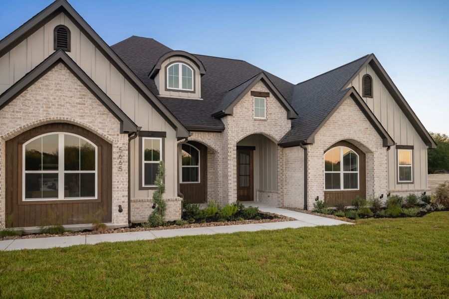 Front exterior of a new home in Windmill Hill, Bryan, TX, highlighting curb appeal (Image 29).