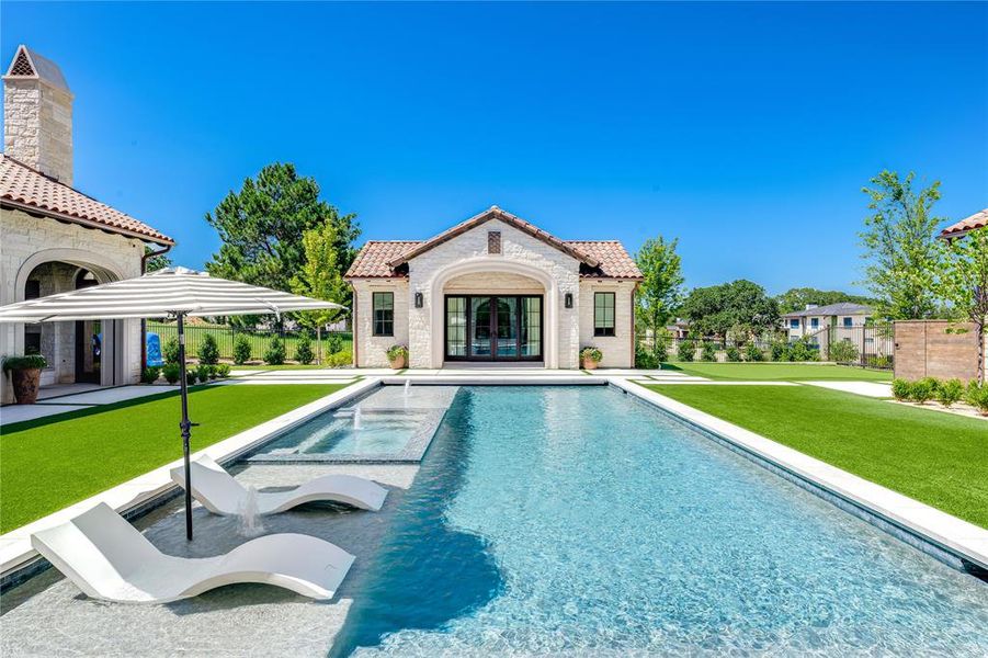 Pool has two tanning decks, hot tub, and a motorized pool cover for child safety.