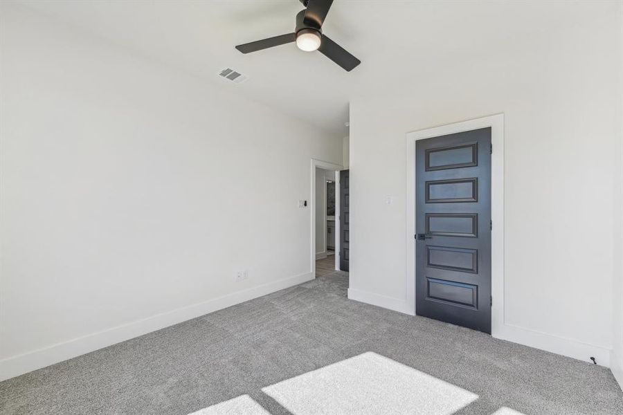 Spare room featuring ceiling fan and light colored carpet