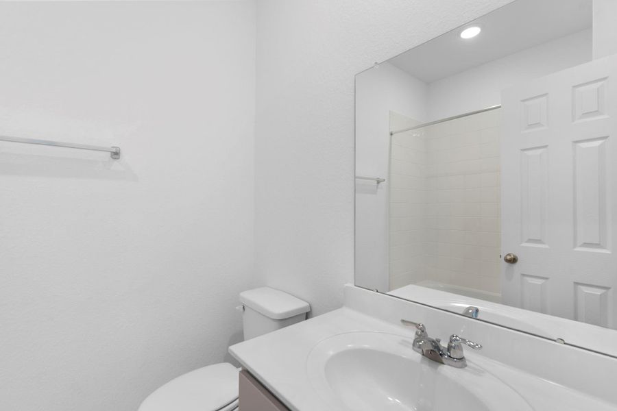 The secondary bath features tile flooring, white cabinetry and light countertops and a shower/tub combo. Perfect for accommodating any visiting family and friends. The secondary bath features tile flooring, white cabinetry and light countertops and a shower/tub combo. Perfect for accommodating any visiting family and friends.