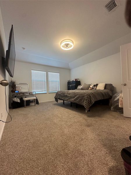 Carpeted bedroom featuring baseboards
