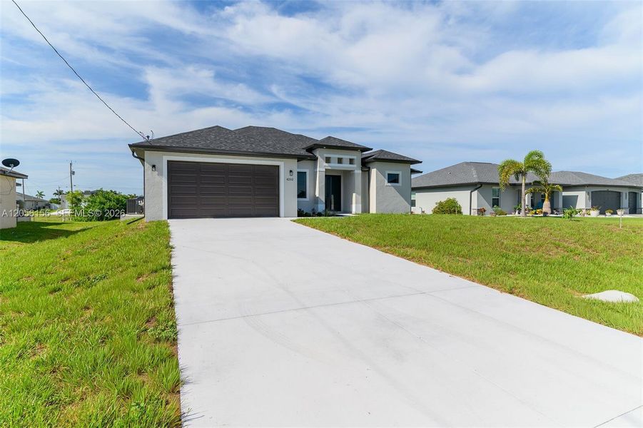 Front exterior of a new home in , Cape Coral, FL, highlighting curb appeal (Image 21). Front exterior of a new home in , Cape Coral, FL, highlighting curb appeal (Image 21).