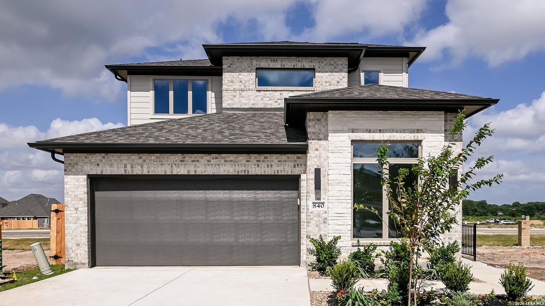 Front exterior of a new home in Legacy at Lake Dunlap, New Braunfels, TX, highlighting curb appeal (Image 2). Front exterior of a new home in Legacy at Lake Dunlap, New Braunfels, TX, highlighting curb appeal (Image 2).