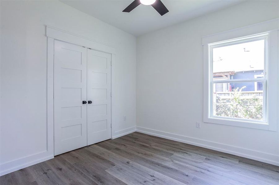 Bright interior featuring wood-finish flooring and a ceiling fan