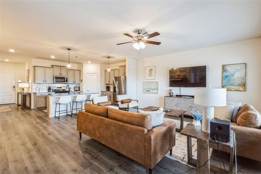 Living room featuring recessed lighting, ceiling fan, and wood finished floors