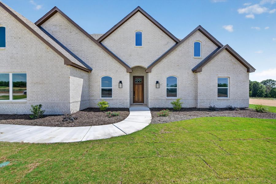 Front exterior of a new home in Taylor Ranch, Springtown, TX, highlighting curb appeal (Image 22).