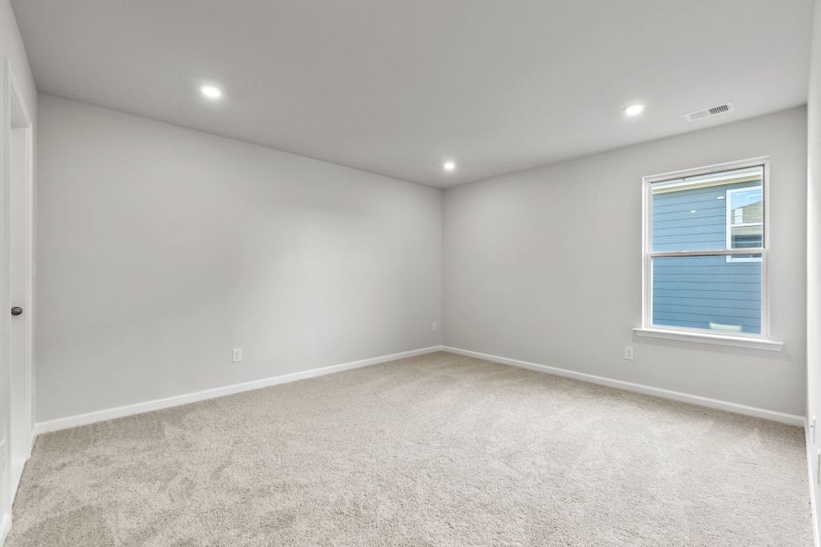 A room with a window and a carpet.