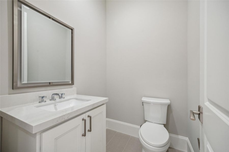Conveniently located off of the third-floor flex space is a powder room. **Photo is of another home in the community and for information purposes only. Buyer to verify all details.** Conveniently located off of the third-floor flex space is a powder room. **Photo is of another home in the community and for information purposes only. Buyer to verify all details.**