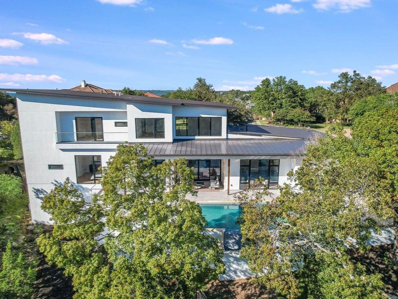A striking modern residence boasts multiple levels, an integrated pool, and generous outdoor spaces. A striking modern residence boasts multiple levels, an integrated pool, and generous outdoor spaces.