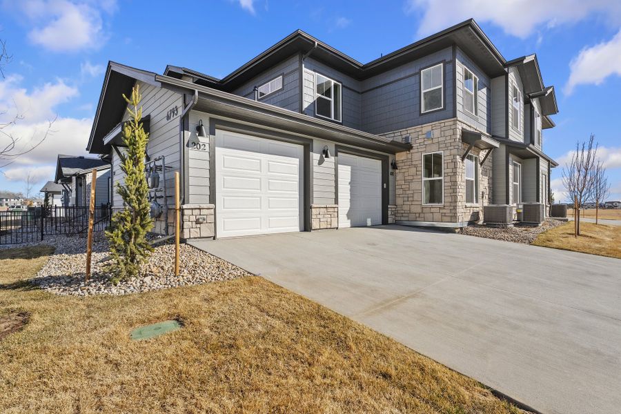 Front exterior of a new home in Wilder at Timnath Ranch, Timnath, CO, highlighting curb appeal (Image 2). Front exterior of a new home in Wilder at Timnath Ranch, Timnath, CO, highlighting curb appeal (Image 2).