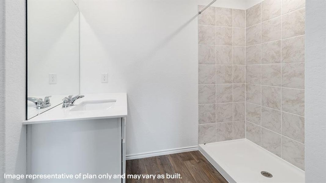 Full bath featuring vanity, a shower stall, and dark wood-type flooring
