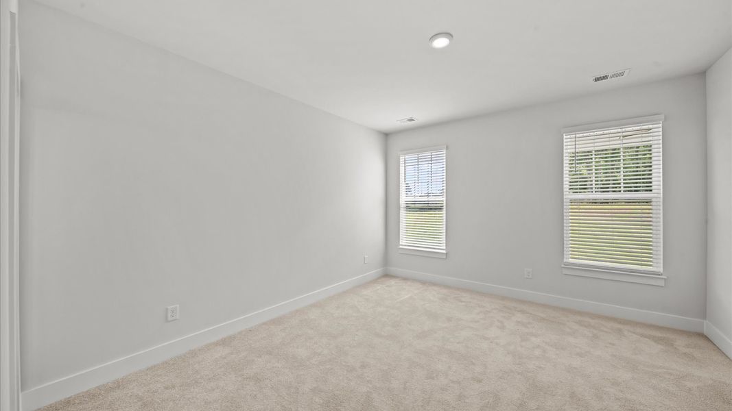 Spacious and serene primary suite with thoughtful design in a desirable DRB Homes community