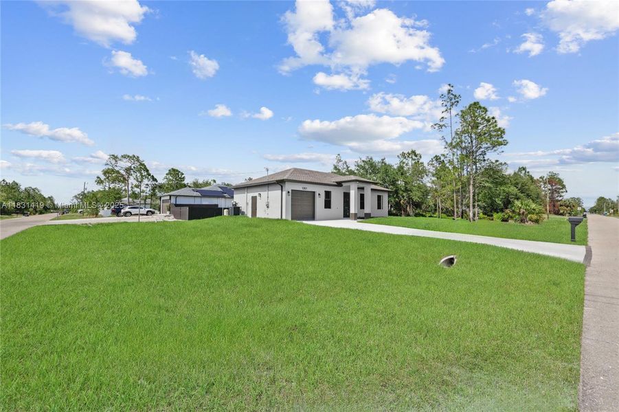 Front exterior of a new home in , Lehigh Acres, FL, highlighting curb appeal (Image 15).