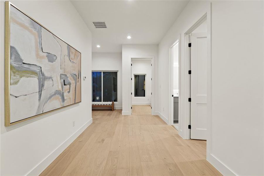 Corridor featuring light wood-style floors and recessed lighting