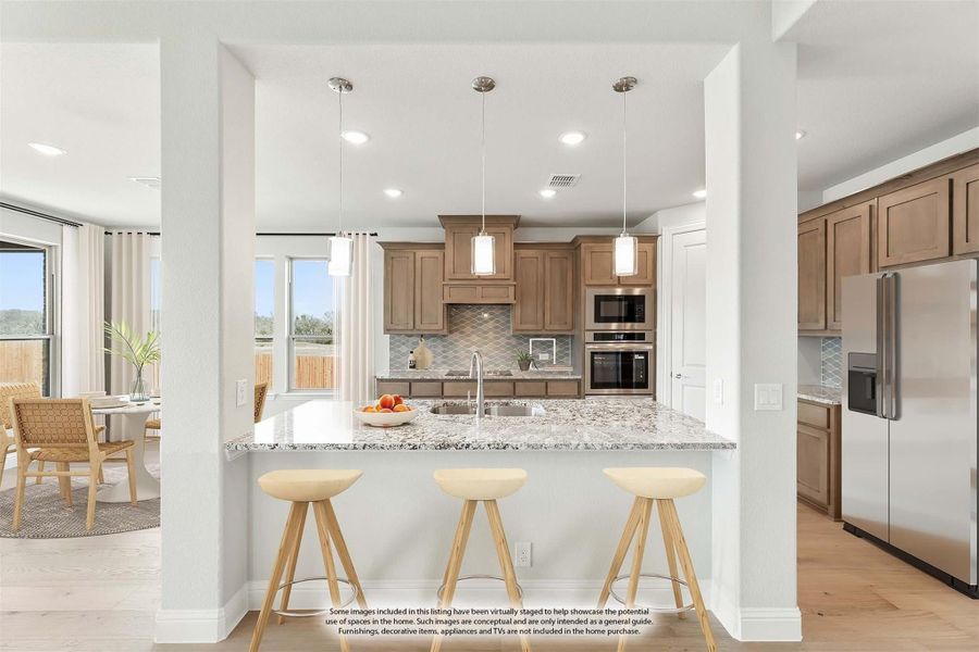 Kitchen with granite island, three bar stools, tan cabinets, pendant lights, and stainless steel appliances Kitchen with granite island, three bar stools, tan cabinets, pendant lights, and stainless steel appliances