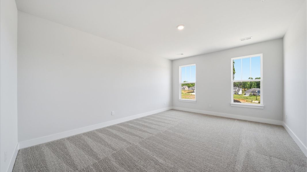 Primary suite that offers first-rate relaxation with established style and elevated finishes at Iris Meadows