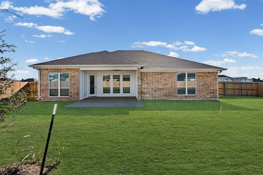 Rear view of house featuring a fenced backyard, a patio area, brick siding, and a shingled roof Rear view of house featuring a fenced backyard, a patio area, brick siding, and a shingled roof