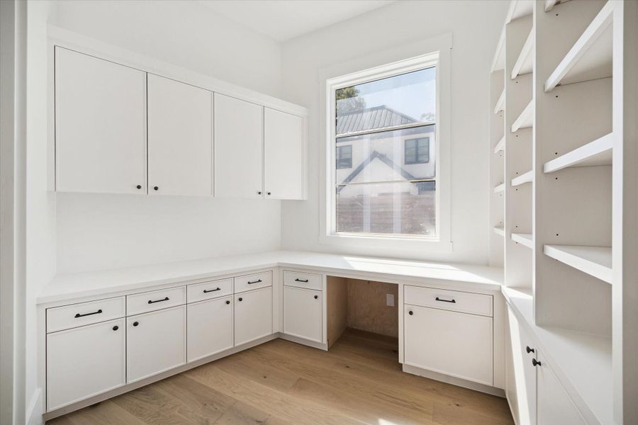Secondary home office or study area with ample built-in cabinetry and shelving. Secondary home office or study area with ample built-in cabinetry and shelving.