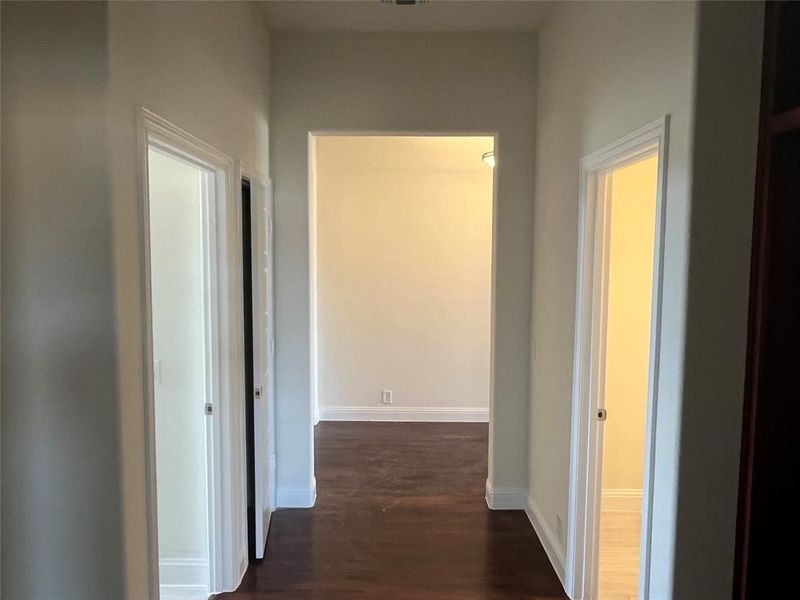 Hallway with dark hardwood / wood-style floors