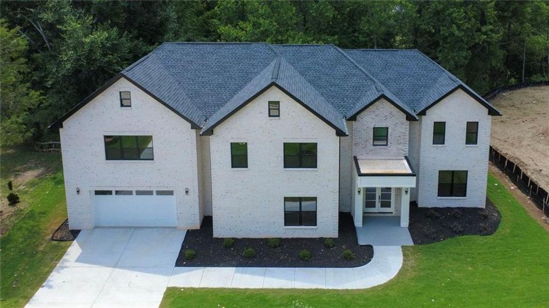 Front exterior of a new home in , Snellville, GA, highlighting curb appeal (Image 36). Front exterior of a new home in , Snellville, GA, highlighting curb appeal (Image 36).