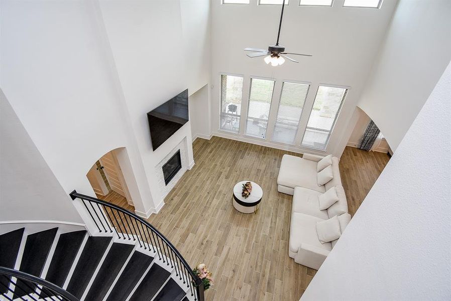 Looking down from the upstairs onto the living room can provide a unique perspective, allowing you to appreciate the layout and design of the space, including any furniture arrangement, decor, and overall ambiance.