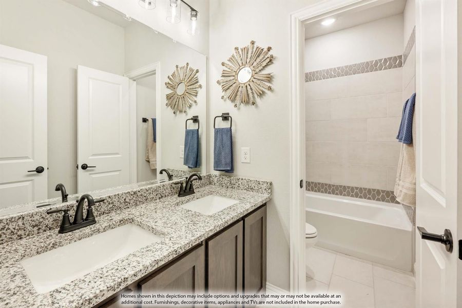 Bathroom with double granite vanity, dark wood cabinets, large mirror, and tiled bathtub with decorative accent strip. Bathroom with double granite vanity, dark wood cabinets, large mirror, and tiled bathtub with decorative accent strip.