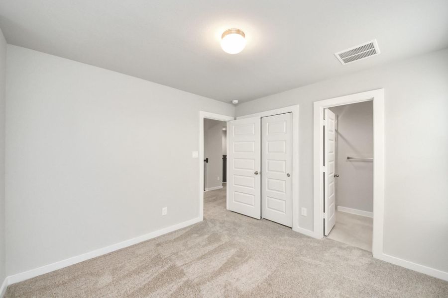 Generously sized secondary bedrooms featuring spacious closets, soft and inviting carpeting underfoot, large windows allowing plenty of natural light, and the added touch of privacy blinds for your personal retreat. Sample photo of completed home with similar floor plan. Actual colors and selections may vary. Generously sized secondary bedrooms featuring spacious closets, soft and inviting carpeting underfoot, large windows allowing plenty of natural light, and the added touch of privacy blinds for your personal retreat. Sample photo of completed home with similar floor plan. Actual colors and selections may vary.