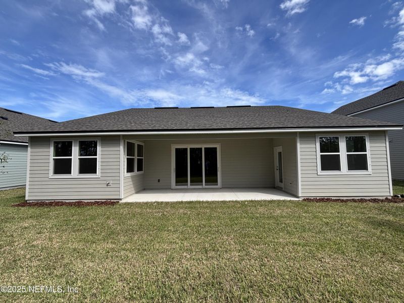 Front exterior of a new home in The Cypress Series at Reserve East, Flagler Beach, FL, highlighting curb appeal (Image 17).