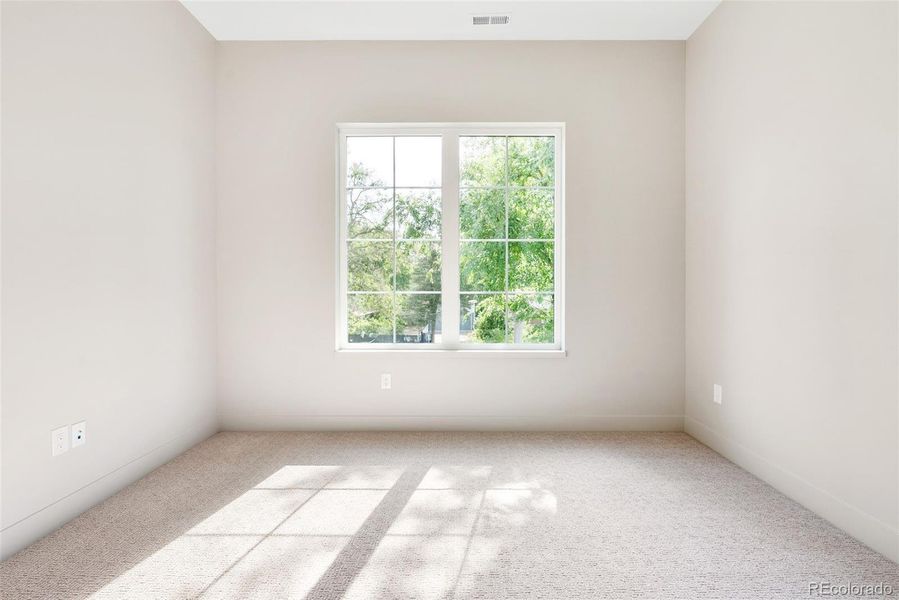 2nd of 3 bedrooms on upper level, en suite bath