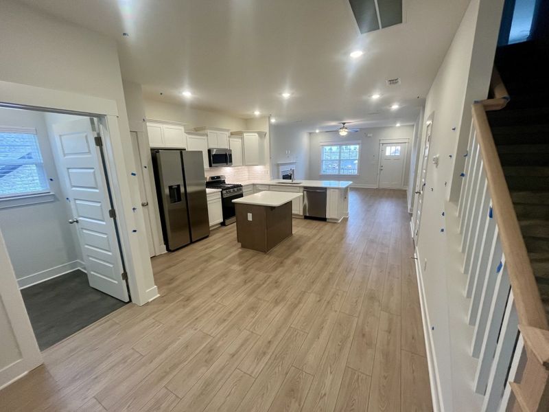 From back door to front door. Laundry room to the left with luxury vinyl tile floor.